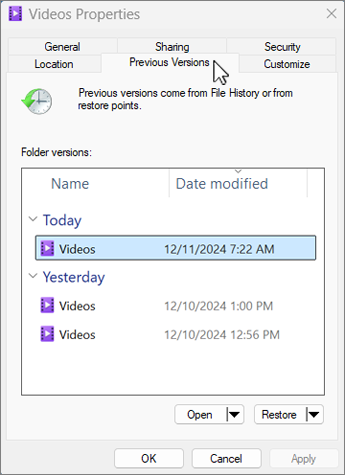 Windows folder properties showing the Previous Versions tab and restoration options